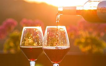 wine being poured into glasses overlooking garden